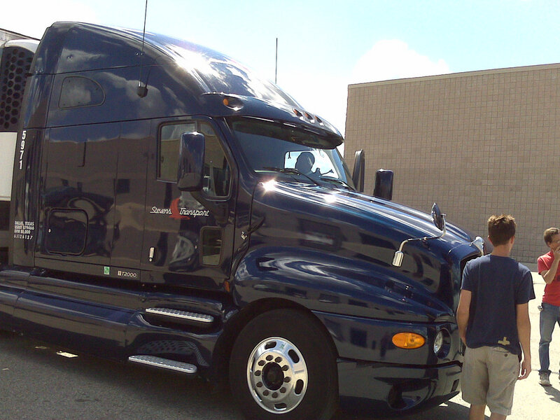 Blue semi-truck parked outside