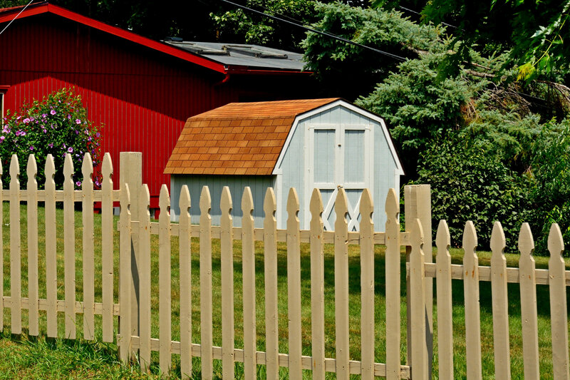 Blue Shed Behind Fence