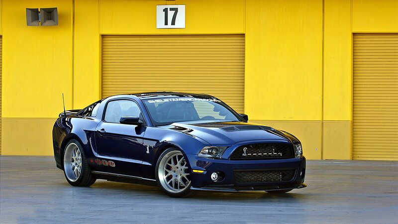 Blue Shelby Mustang in front of garage