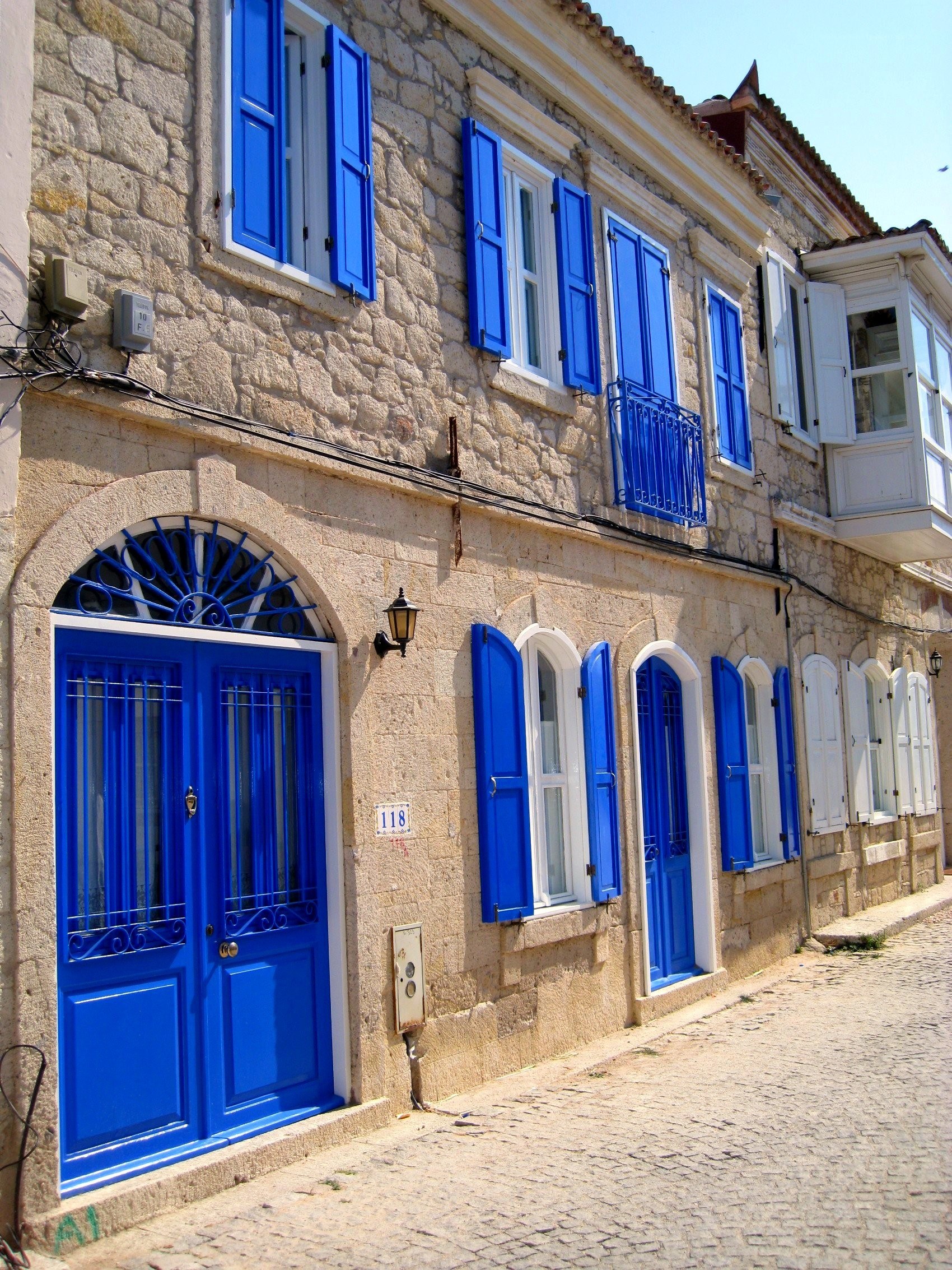 Blue-shuttered stone buildings
