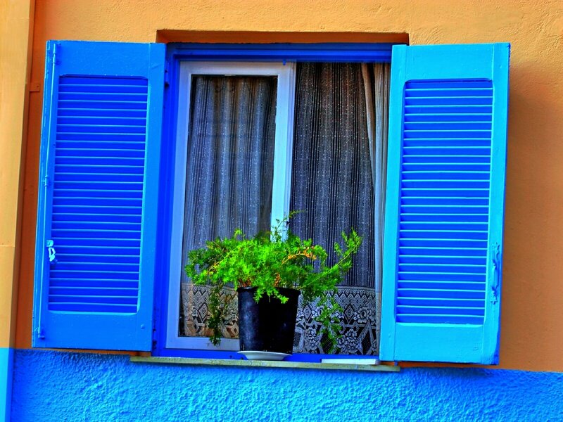 blue shutters on a colorful wall