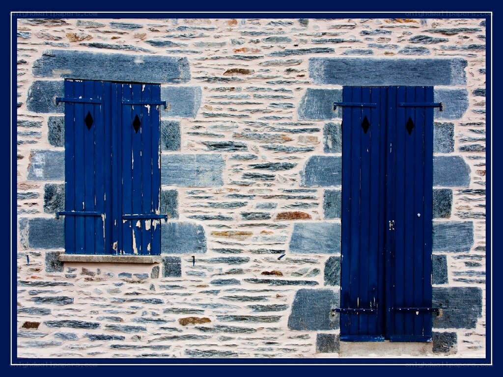 blue shutters on stone wall