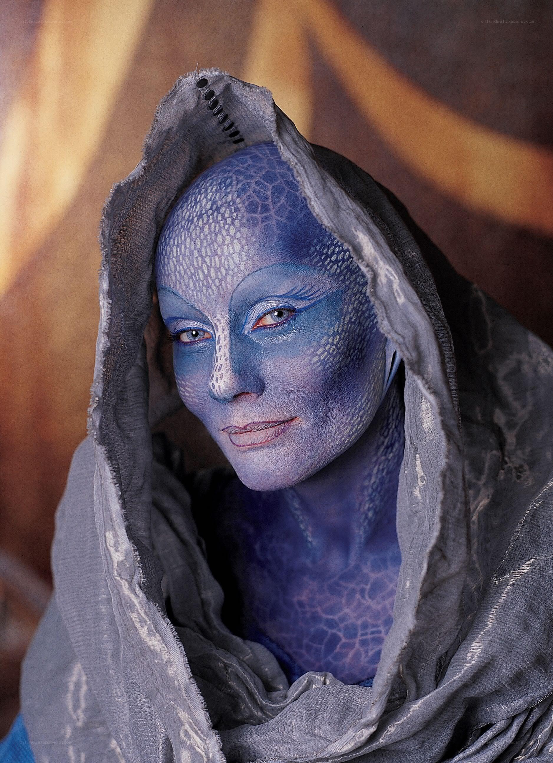 blue-skinned alien in hood
