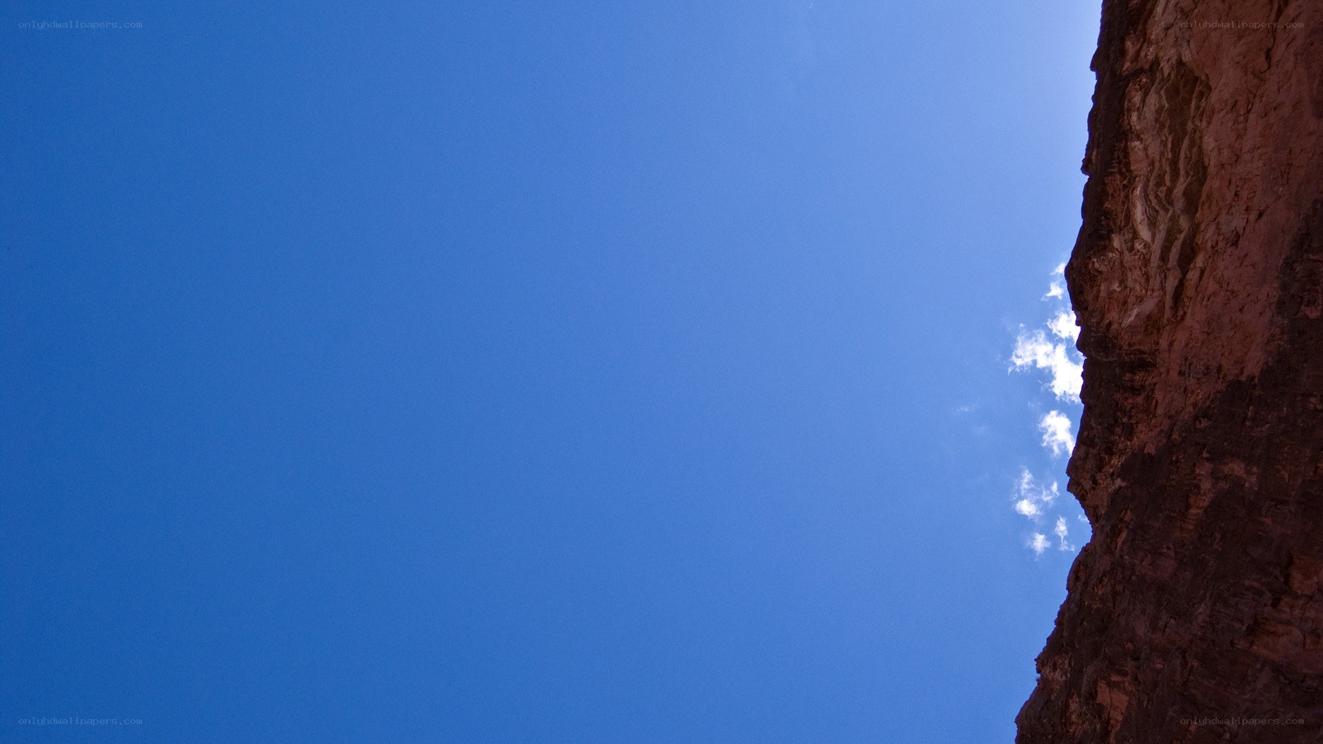 blue sky above canyon wall