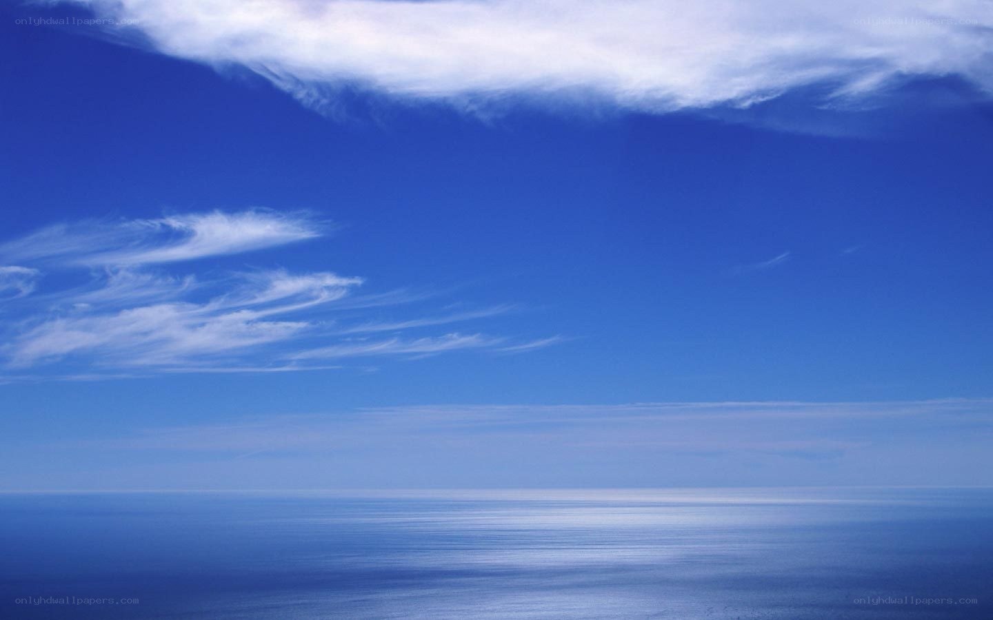 Blue sky over calm ocean