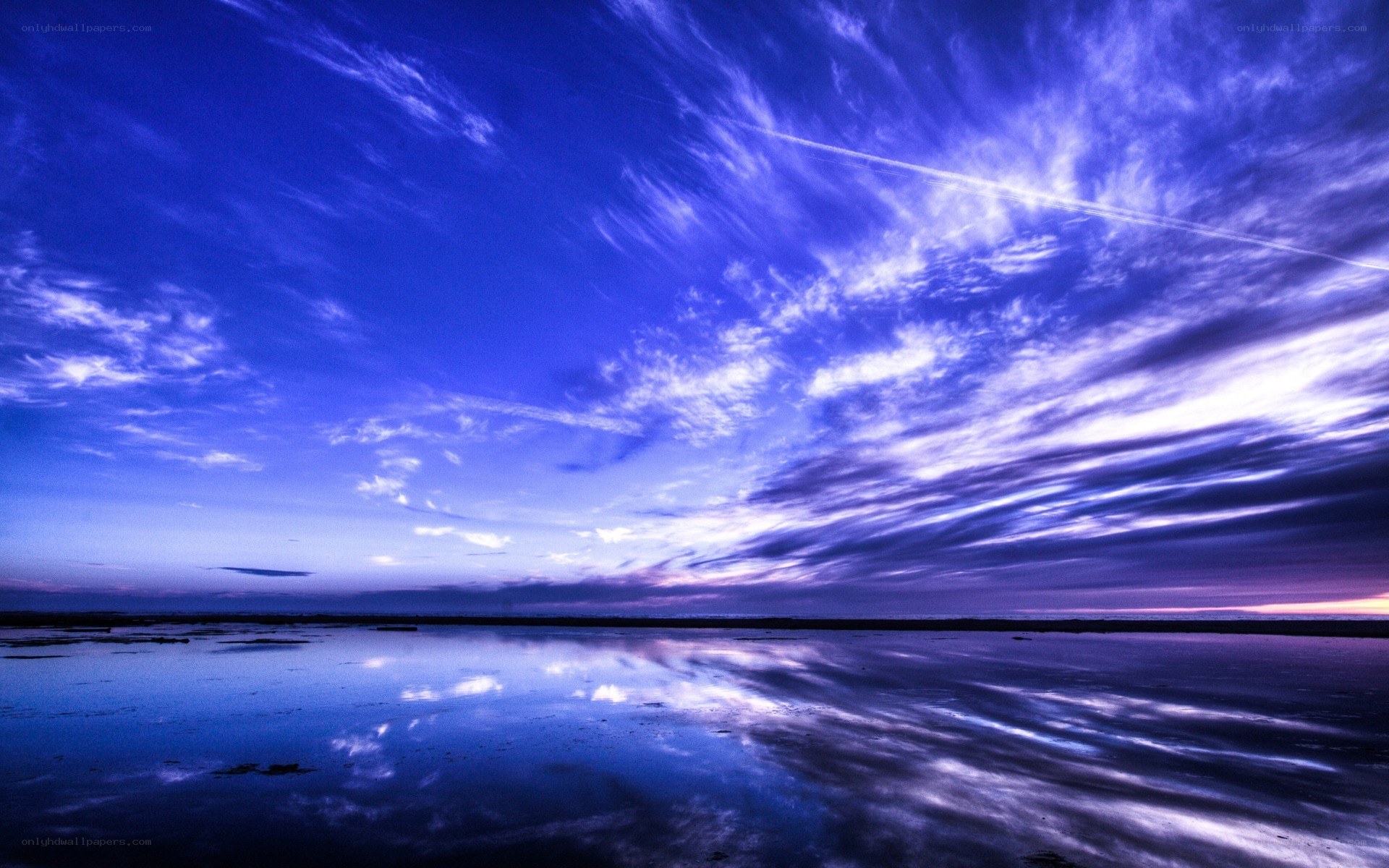 Blue sky over calm water