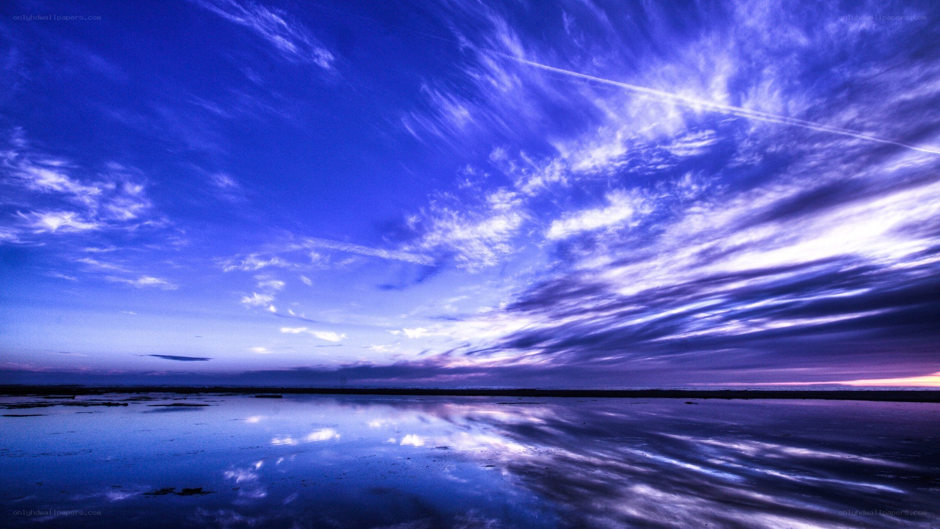 Blue sky over calm water