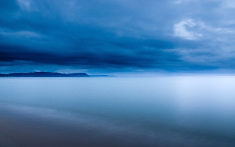 Blue sky over calm water