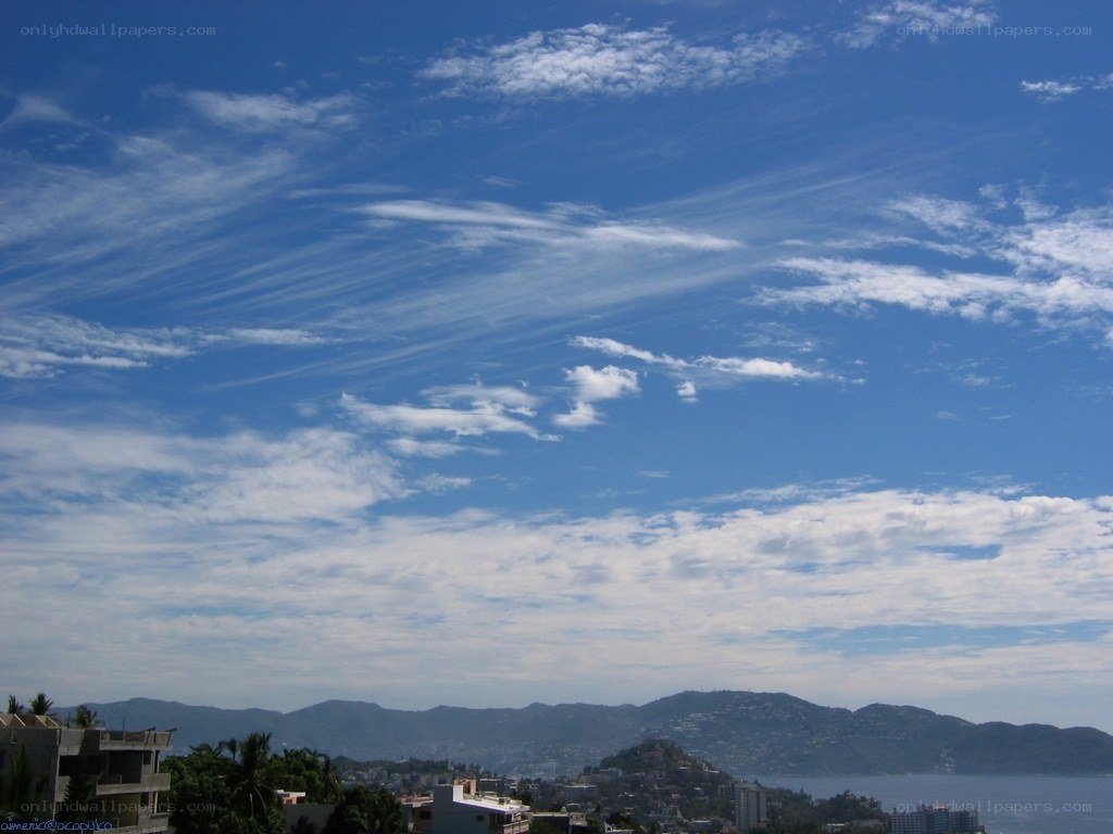 Blue sky over coastal city