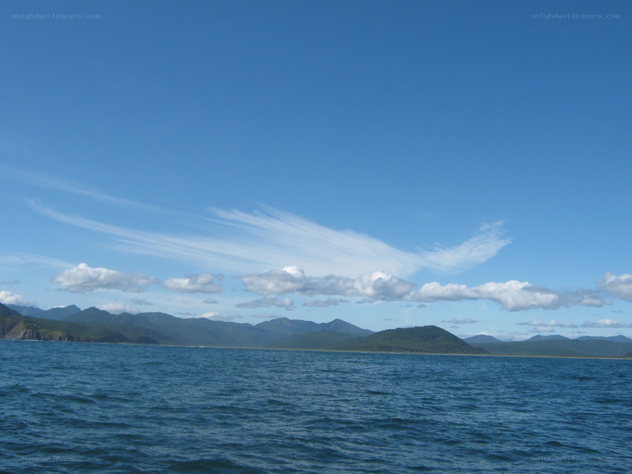 Blue sky over mountain lake
