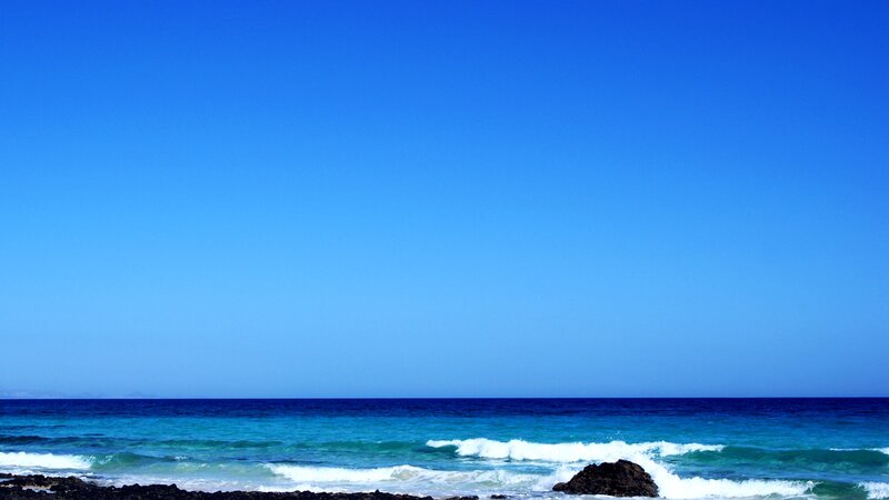 Blue sky over ocean waves