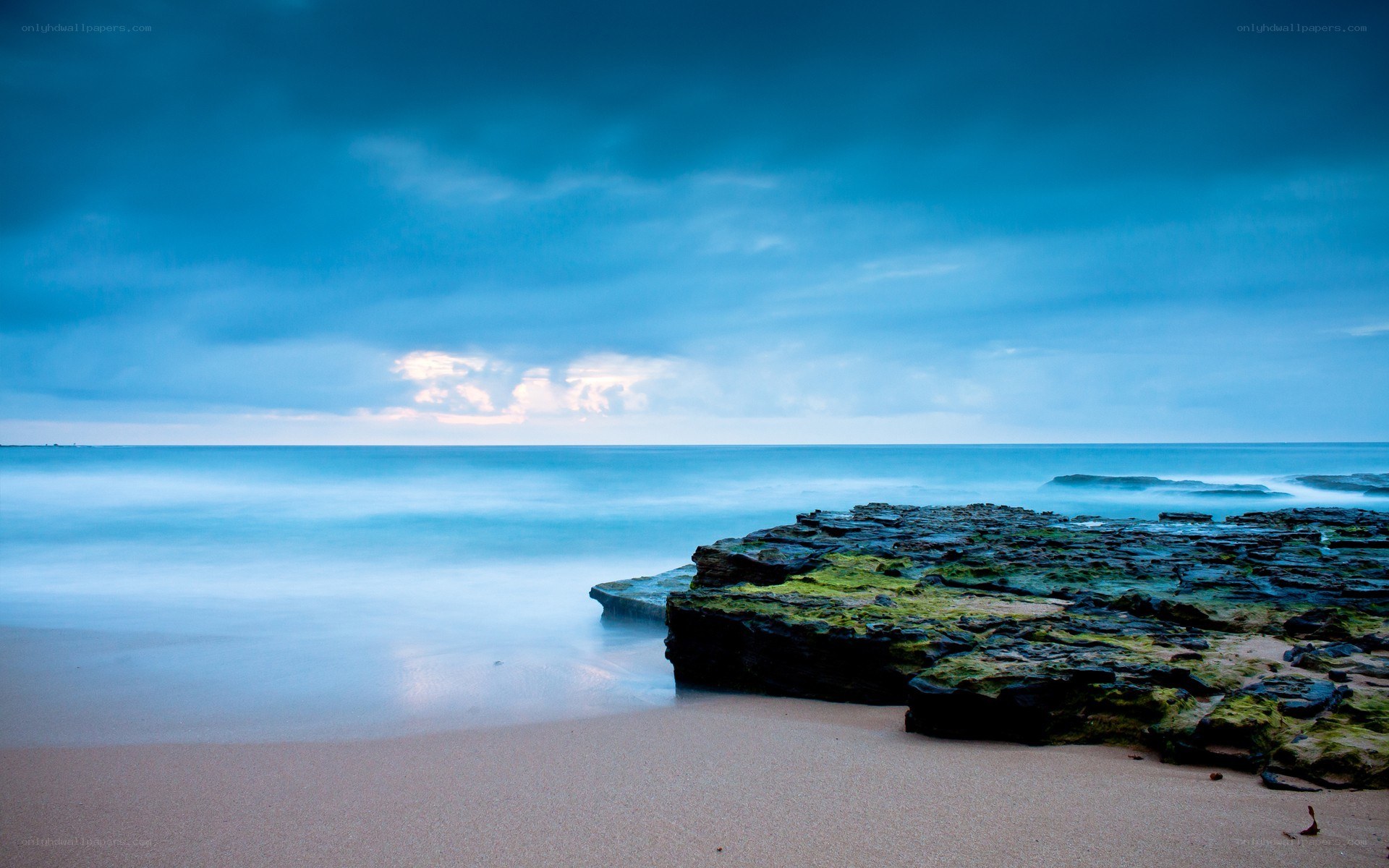 Blue sky over rocky beach