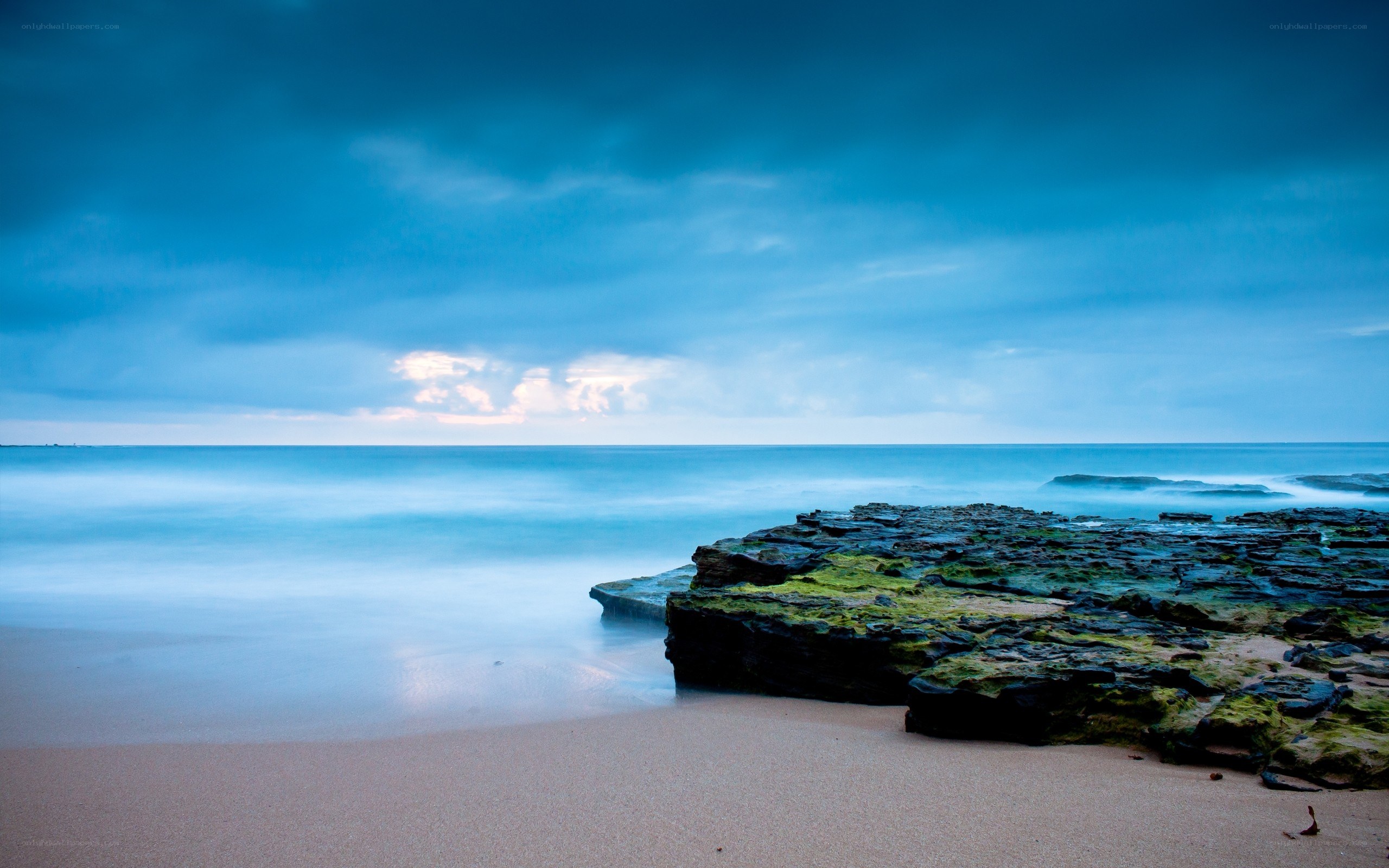 Blue sky over rocky beach
