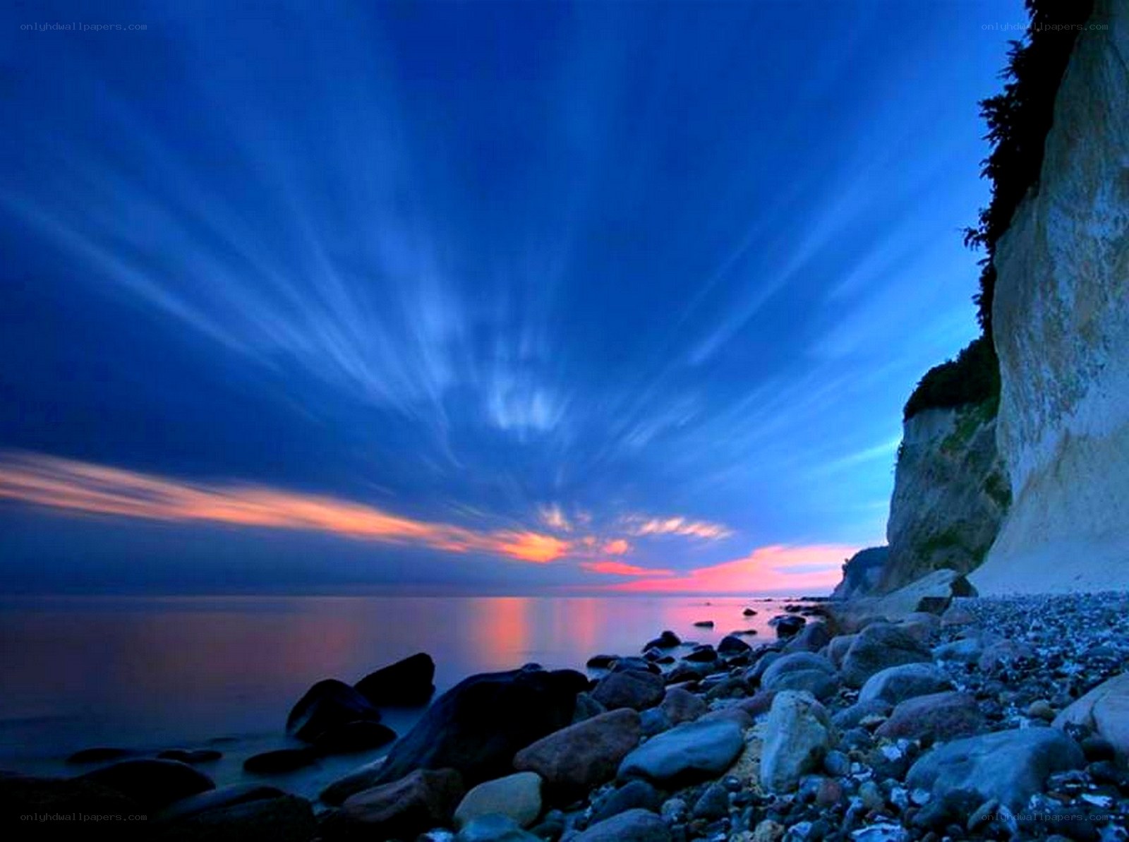 Blue sky over rocky beach