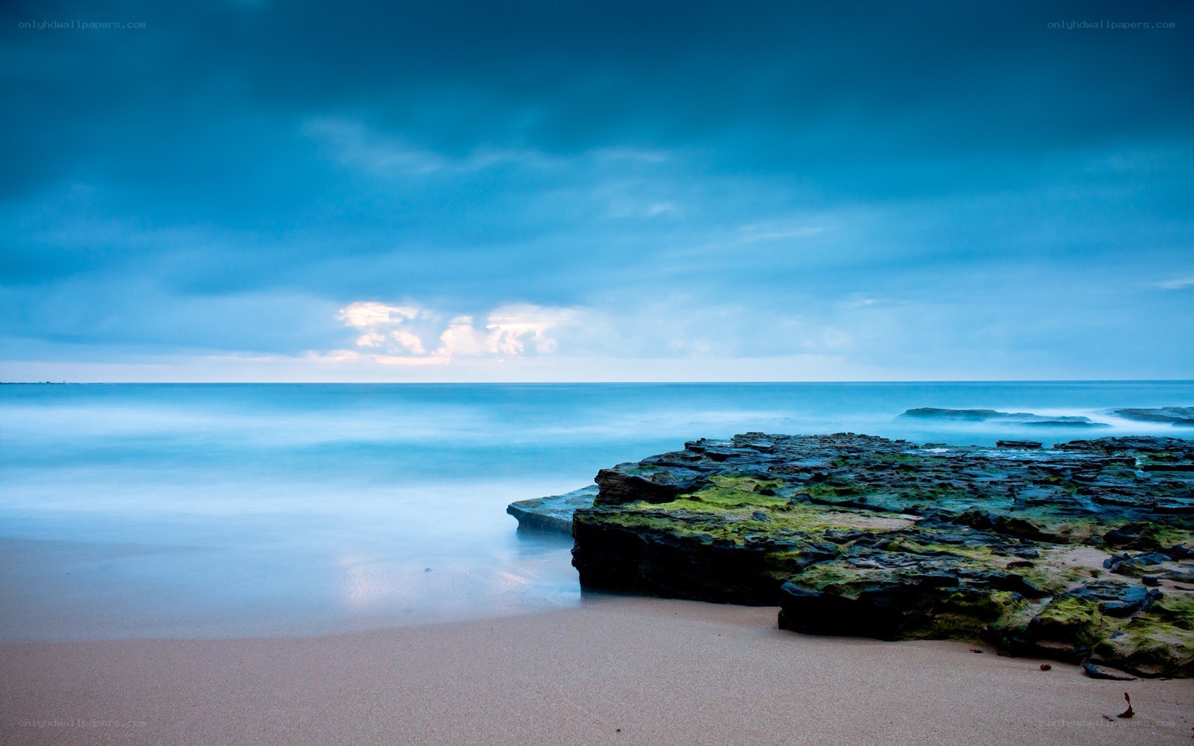Blue sky over rocky beach