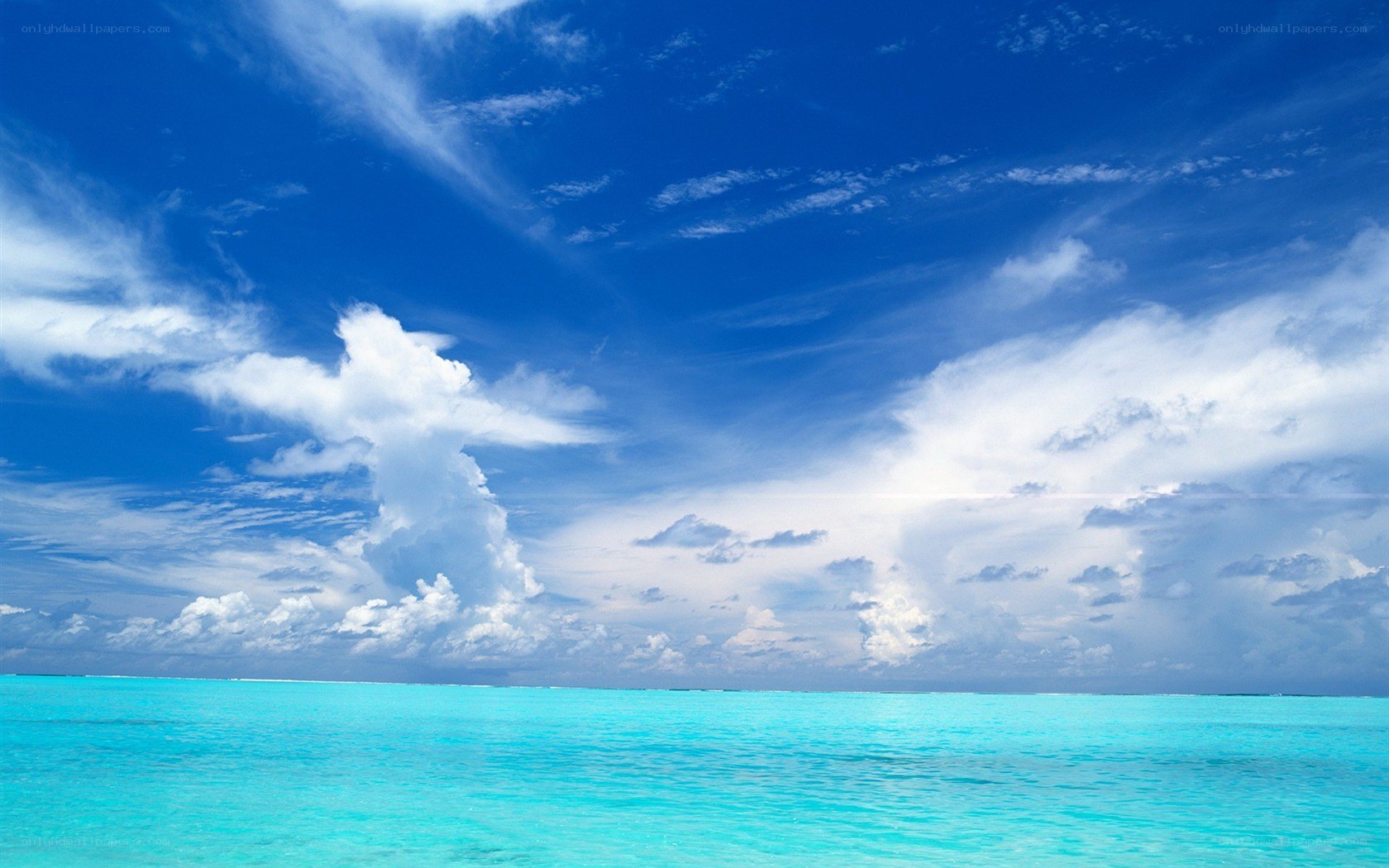 Blue sky over turquoise ocean
