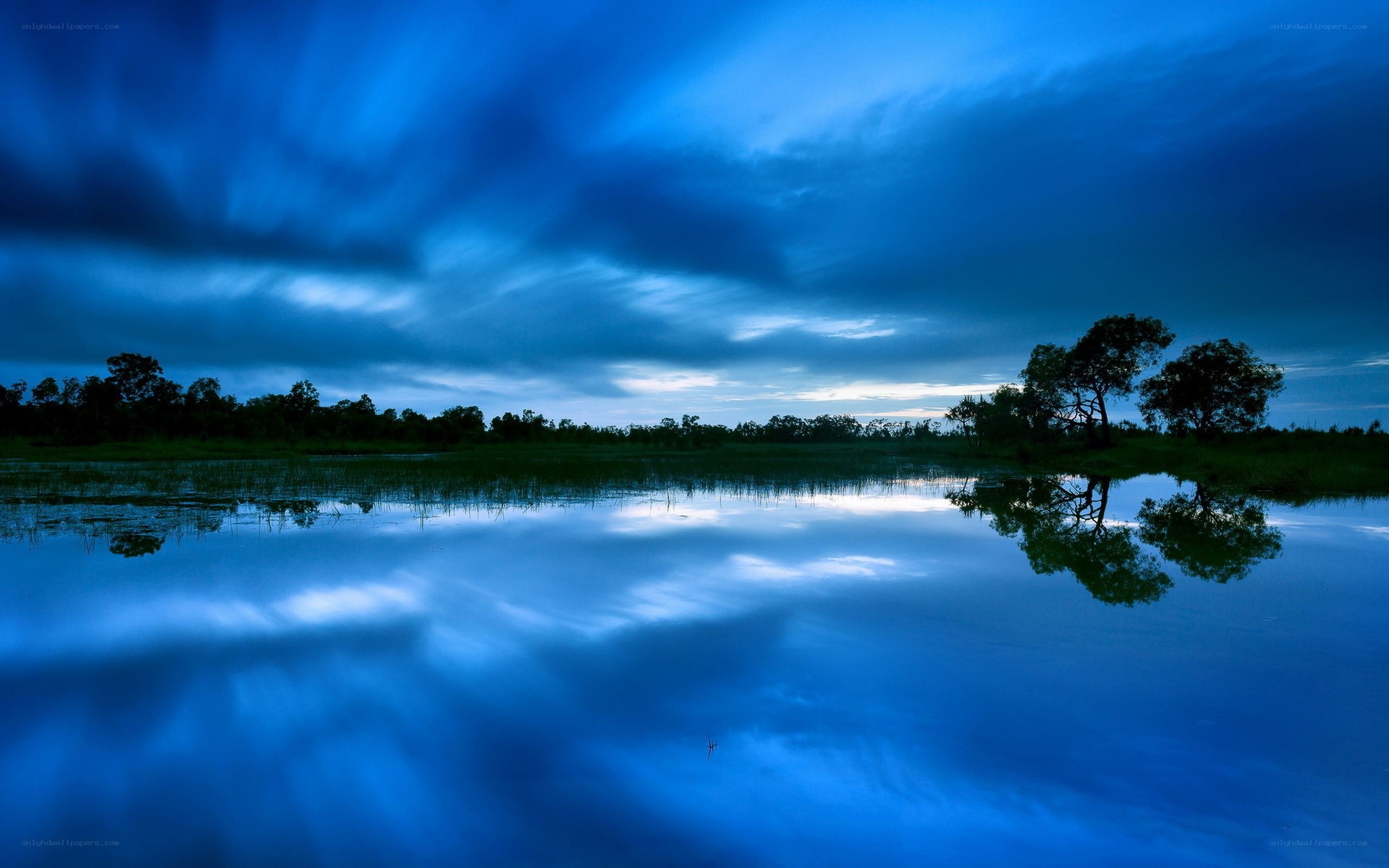Blue sky reflected in calm water