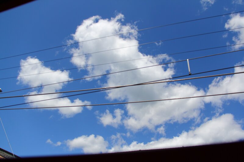 Blue sky with clouds and wires