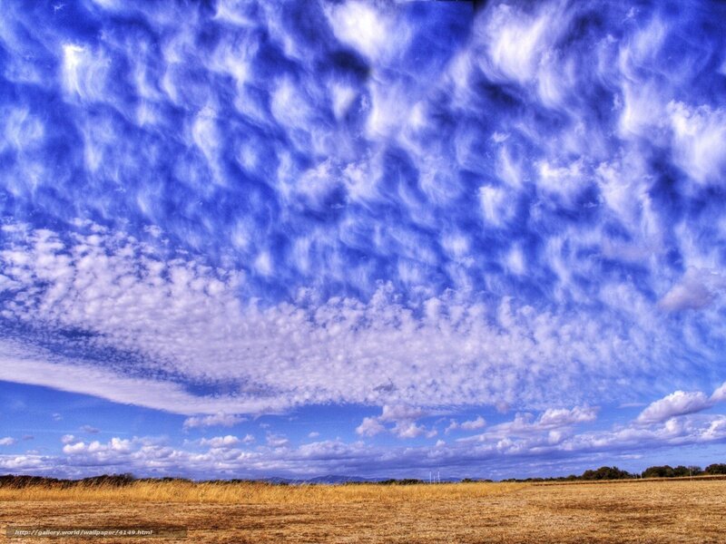 Blue sky with clouds over field