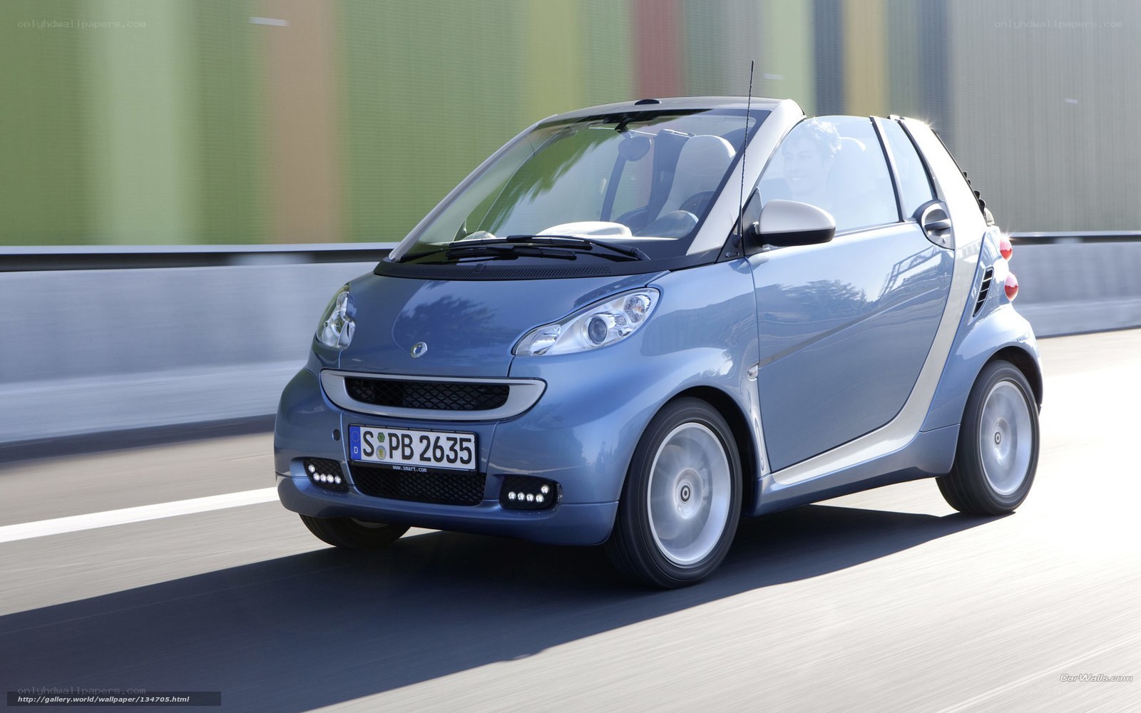 blue smart car in motion