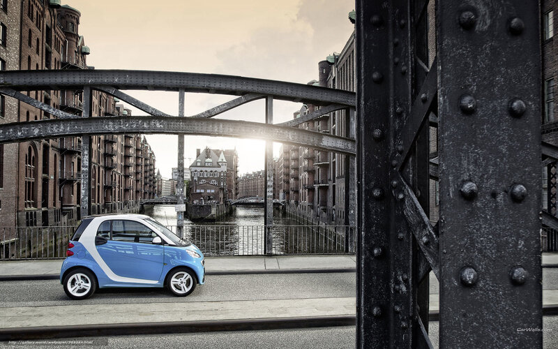 Blue smart car on a bridge