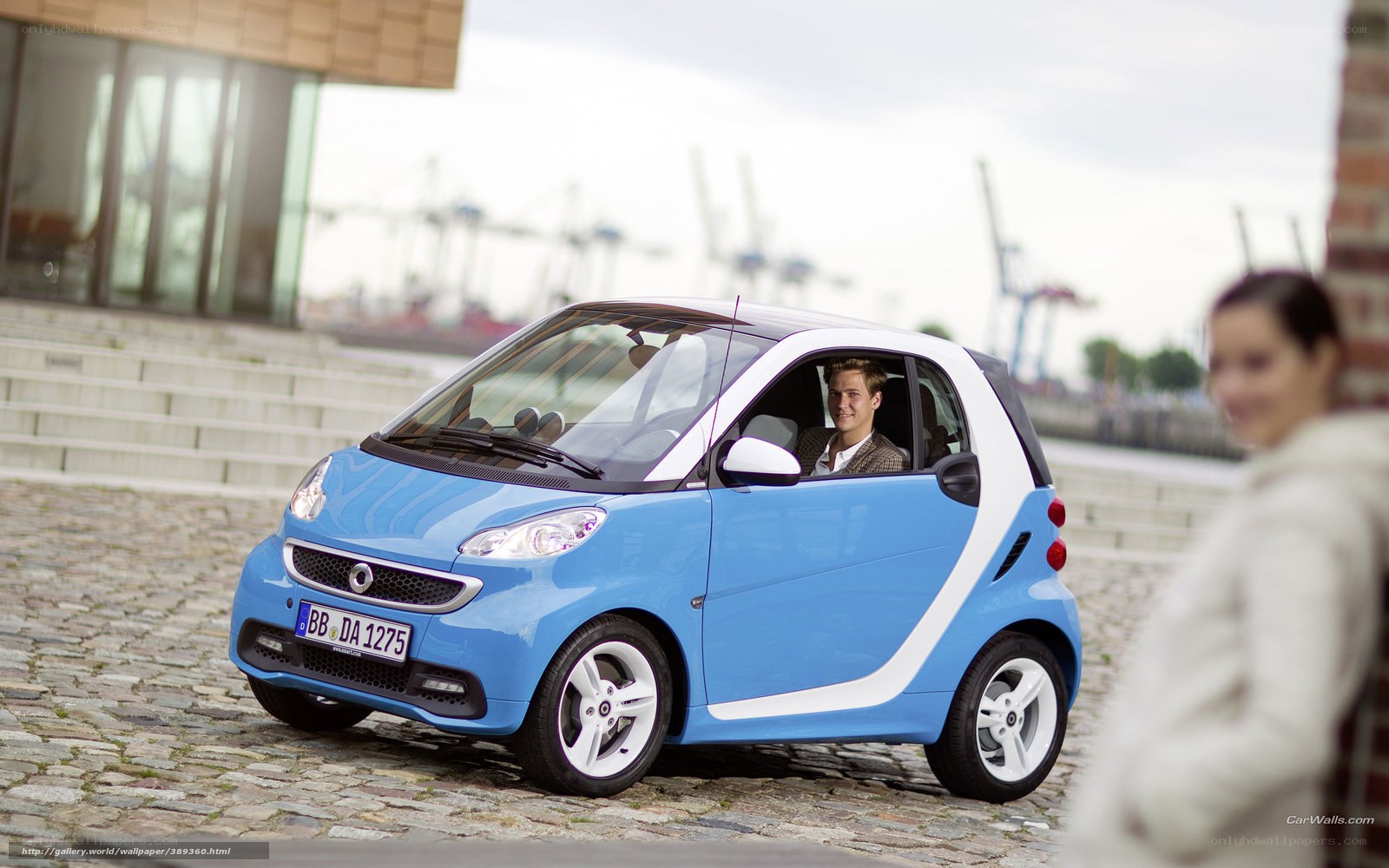 Blue smart car on cobblestones