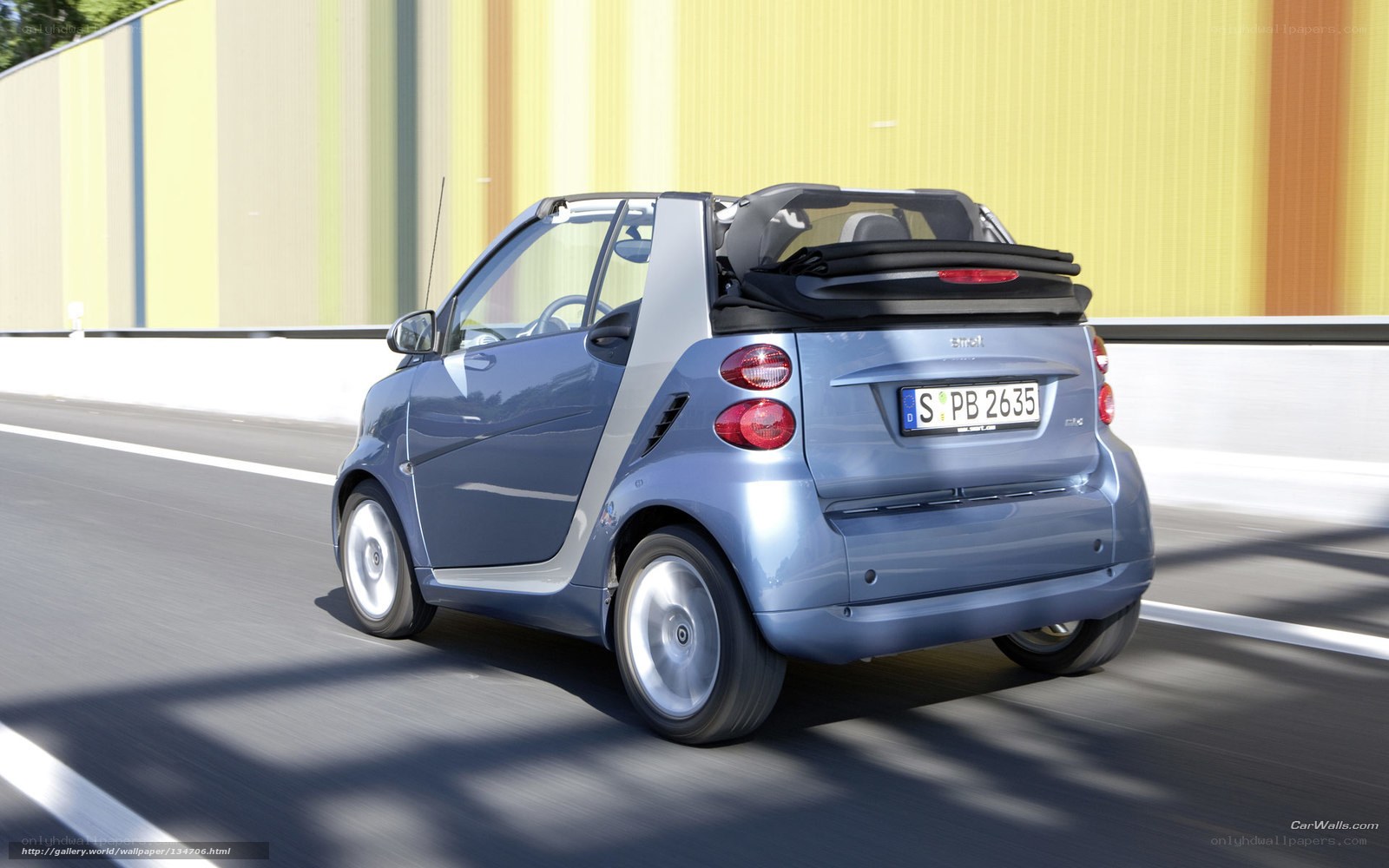 blue smart car on road