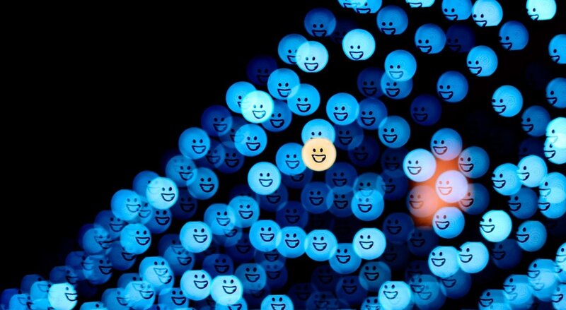 blue smiley faces in crowd