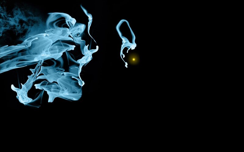 Blue smoke swirls on black