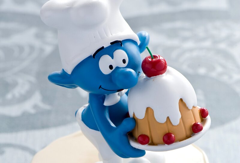 Blue Smurf Holding Cake
