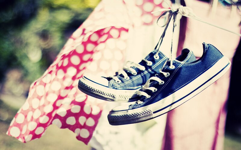 blue sneakers hanging on clothesline