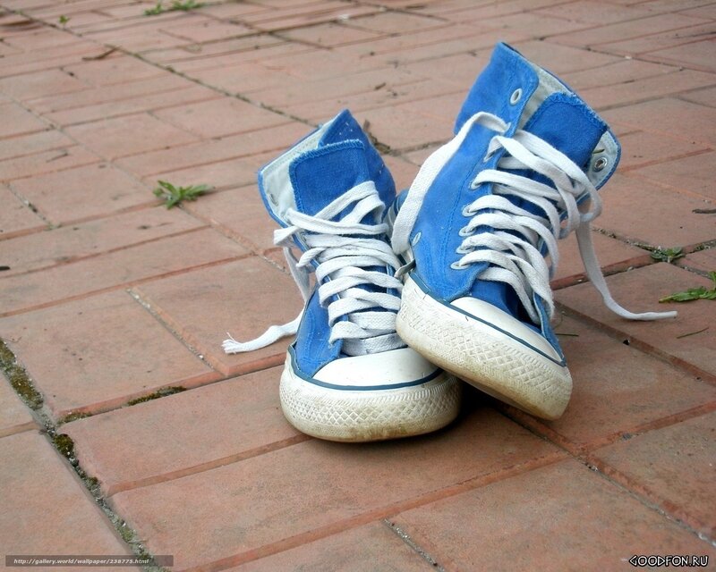blue sneakers on brick pavement