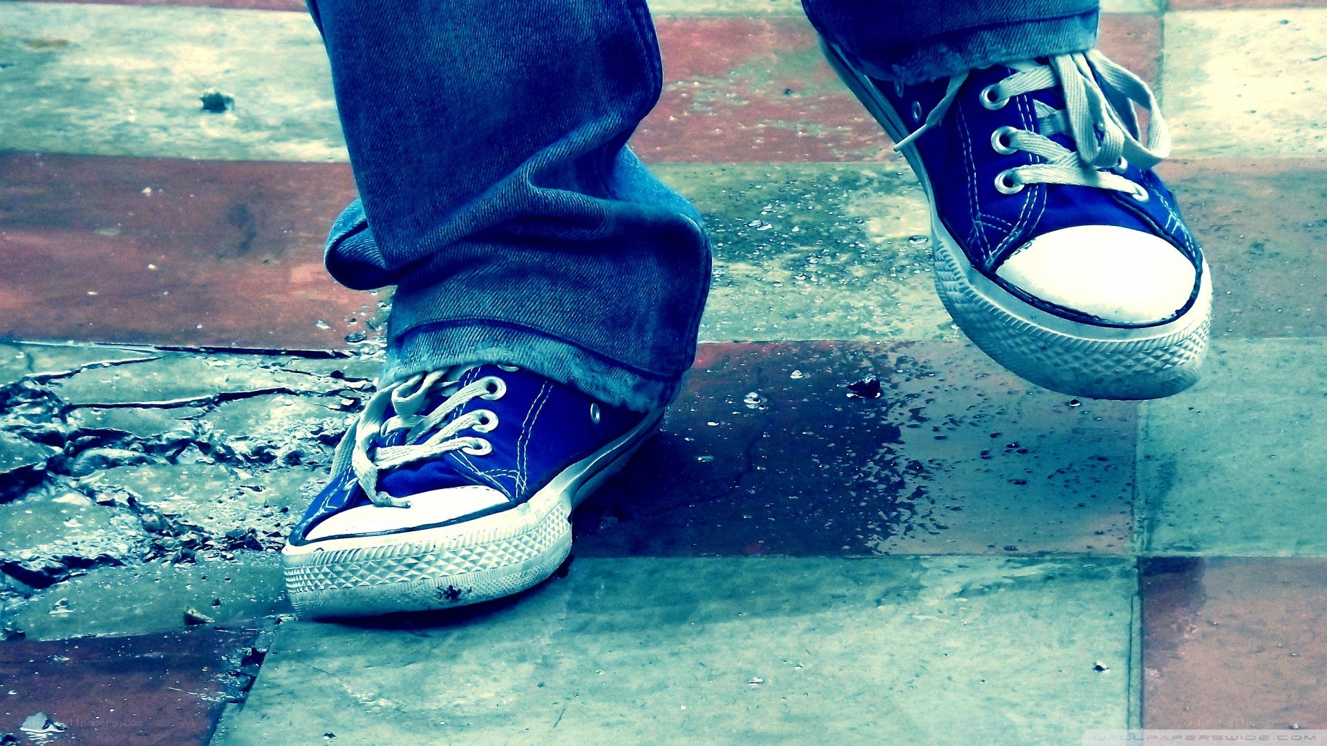blue sneakers on wet pavement