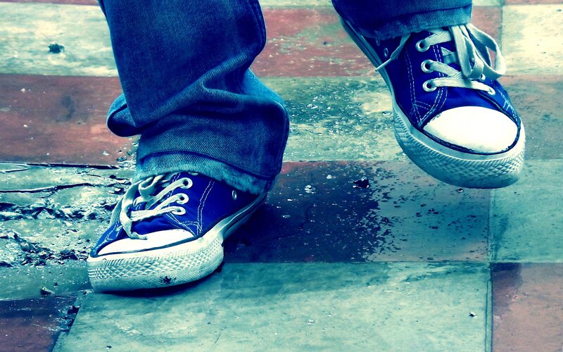 blue sneakers on wet pavement