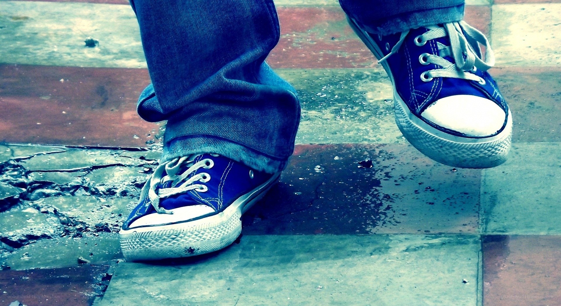 blue sneakers on wet pavement