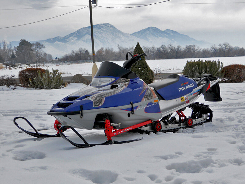 Blue Snowmobile in Snow