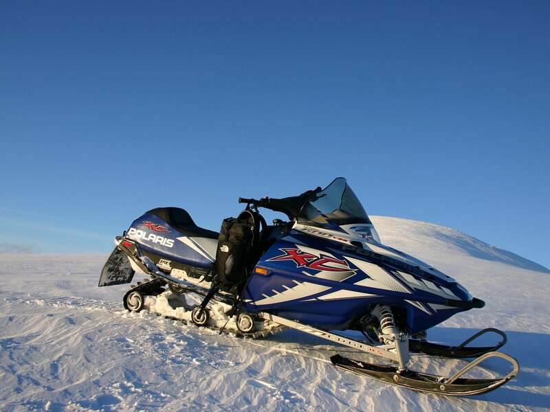 Blue Snowmobile on Snow
