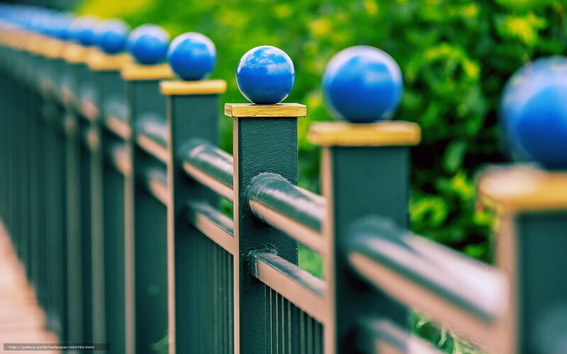 blue spheres on fence posts