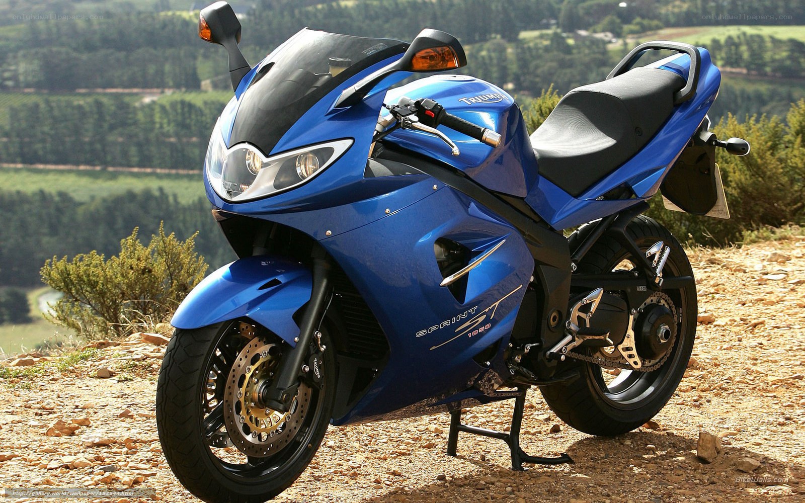 blue sport motorcycle on hillside