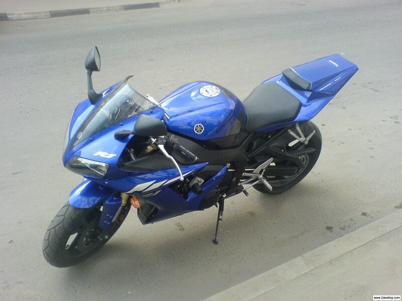 blue sport motorcycle on street
