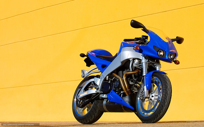 Blue sport motorcycle on yellow wall