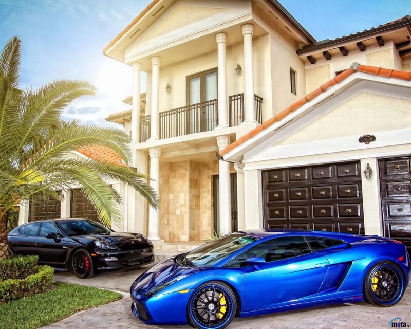 Blue Sports Car and Black Sedan — Luxurious