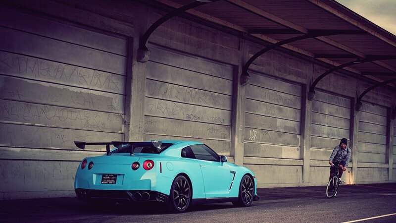 Blue sports car and cyclist