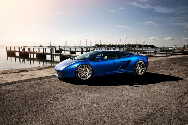 Blue sports car at a marina