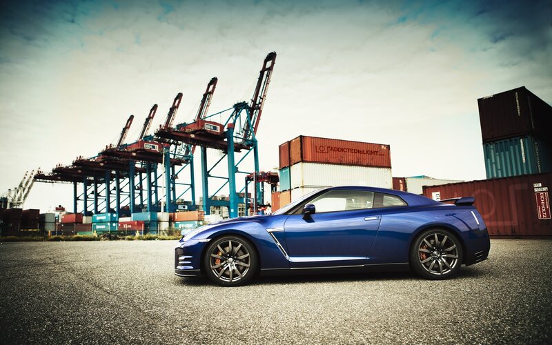 Blue sports car at a port