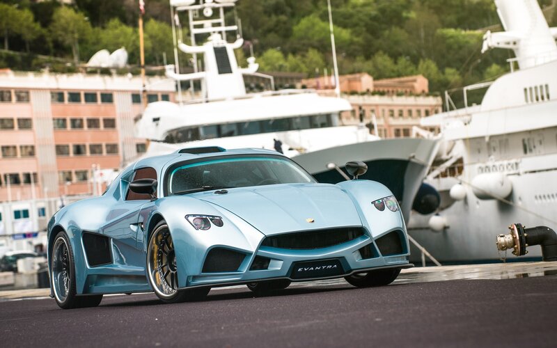 Blue sports car at marina