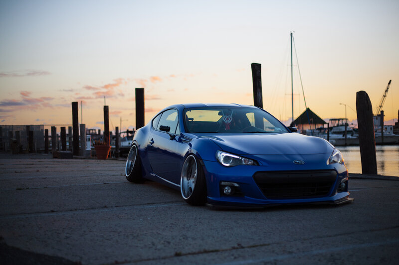 Blue sports car at sunset