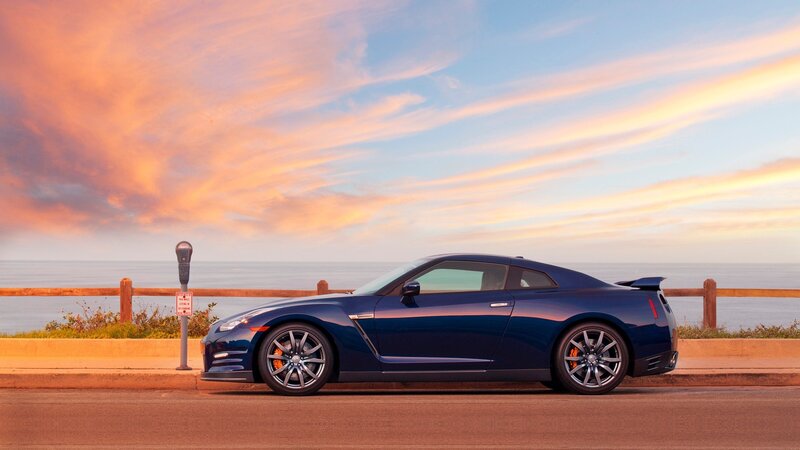 Blue sports car at sunset