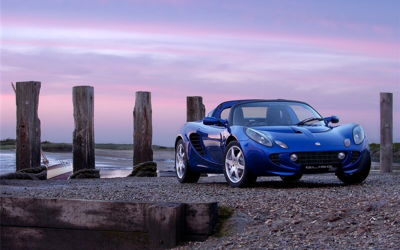 Blue sports car at sunset