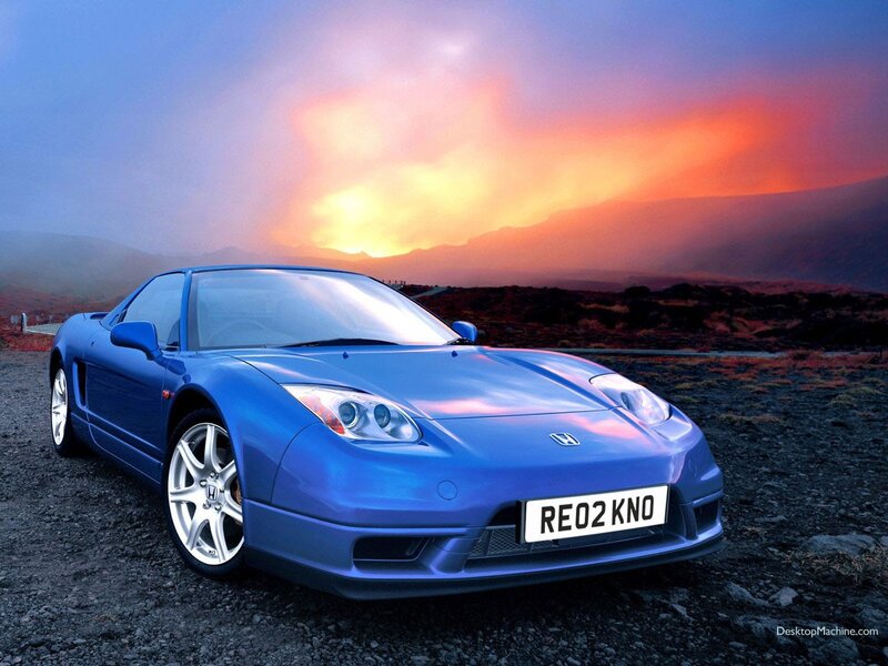 Blue sports car at sunset